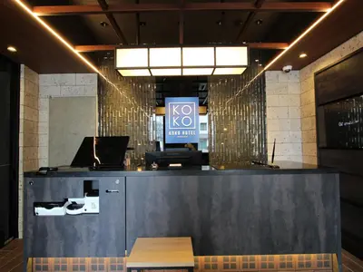 a lobby with a counter with a laptop on it at KOKO HOTEL Residence Asakusa Tawaramachi in Tokyo