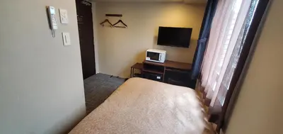 a small room with a bed and a tv at HOTEL LiVEMAX Kamata Ekimae in Tokyo