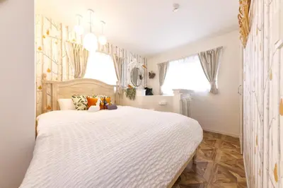 a bedroom with a large white bed in a room at Holy Town in Tokyo