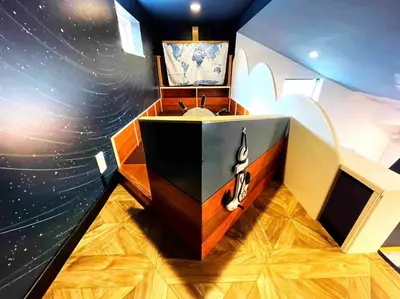 a bathroom with a space themed wall with a sink at Holy Town in Tokyo