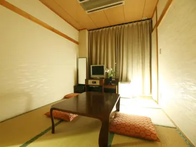 a living room with a table and a window at Hotel New Ueno in Tokyo