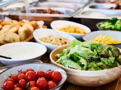 a table topped with bowls of tomatoes and other foods at APA Hotel Asakusabashi Ekimae in Tokyo