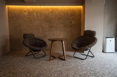 two chairs and a table in a room at SAUNALAND ASAKUSA in Tokyo