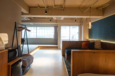 a living room with a couch and a tv at SAUNALAND ASAKUSA in Tokyo