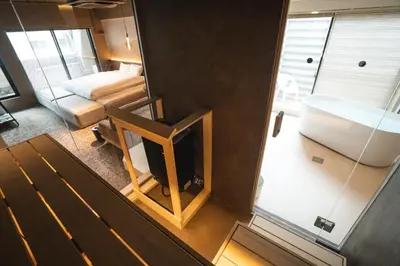 an overhead view of a room with a bed and a mirror at SAUNALAND ASAKUSA in Tokyo