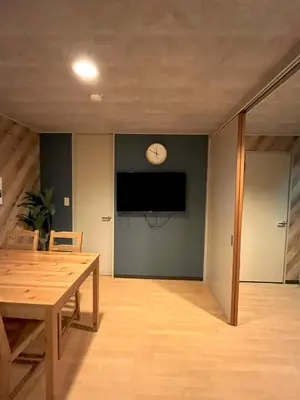 a dining room with a table and a clock on a wall at Green House Nakano Fujimicho - Vacation STAY 66008v in Tokyo