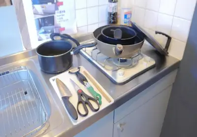 a kitchen counter with two pots and pans on a stove at Green House Nakano Fujimicho - Vacation STAY 66008v in Tokyo