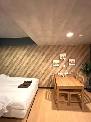 a bedroom with a bed and a wooden table at Green House Nakano Fujimicho - Vacation STAY 66008v in Tokyo