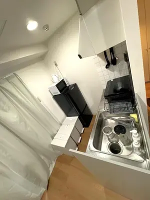 a small kitchen with a sink and a stove at Green House Nakano Fujimicho - Vacation STAY 65981v in Tokyo