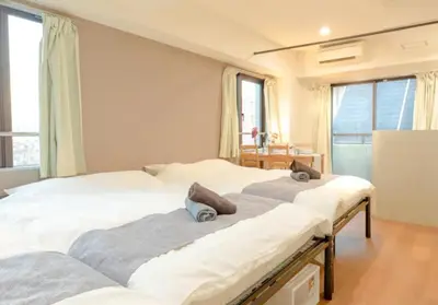 two large beds in a room with windows at Green House Nakano Fujimicho - Vacation STAY 65981v in Tokyo