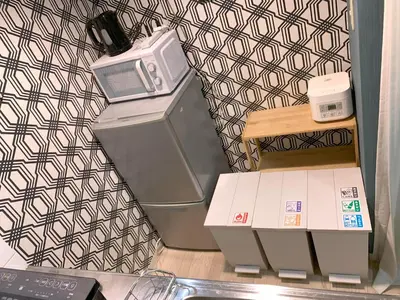 a kitchen with a microwave on top of a refrigerator at Green House Nakano Fujimicho - Vacation STAY 65992v in Tokyo