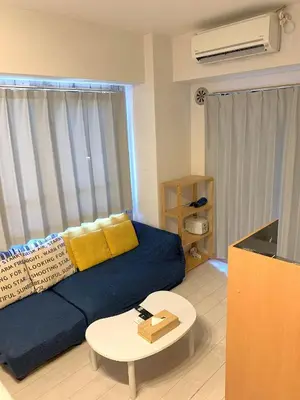 a living room with a blue couch and a table at Green House Nakano Fujimicho - Vacation STAY 65988v in Tokyo
