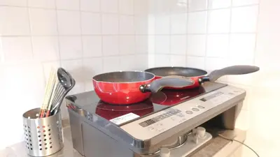 a red pot sitting on top of a stove at Green House Nakano Fujimicho - Vacation STAY 65983v in Tokyo