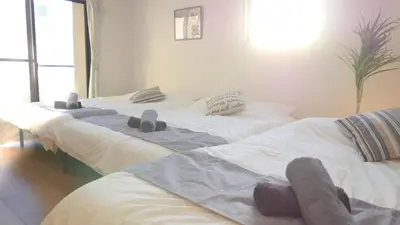 two beds in a room with towels on them at Green House Nakano Fujimicho - Vacation STAY 65983v in Tokyo