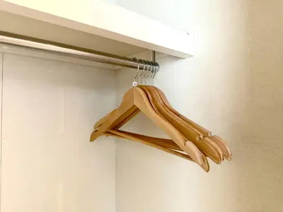 a pair of wooden hangers are hanging from a closet at Green House Nakano Fujimicho - Vacation STAY 65976v in Tokyo