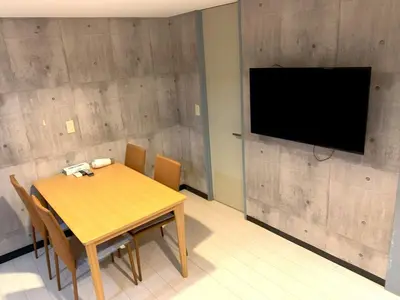 a dining room with a wooden table and a flat screen tv at Green House Nakano Fujimicho - Vacation STAY 65976v in Tokyo