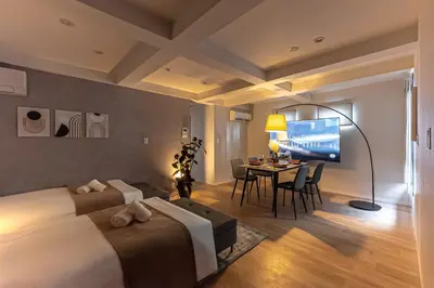 a hotel room with a bed and a dining room at URBAN STAY SHINJUKU EAST - Vacation STAY 67905v in Tokyo