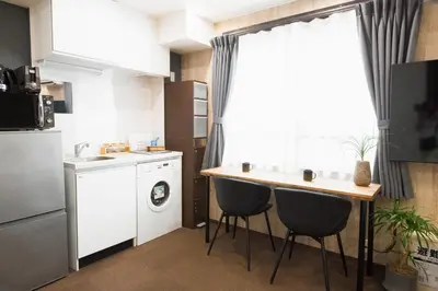 a small kitchen with a table and a sink at URBAN STAY SHINJUKU EAST - Vacation STAY 67900v in Tokyo