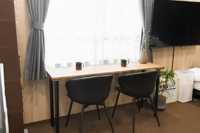 a table with two chairs in front of a window at URBAN STAY SHINJUKU EAST - Vacation STAY 67909v in Tokyo