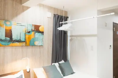 a room with a bed and a painting on the wall at URBAN STAY SHINJUKU EAST - Vacation STAY 67909v in Tokyo