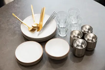 a table with plates and spoons and glasses on it at URBAN STAY SHINJUKU EAST - Vacation STAY 67909v in Tokyo
