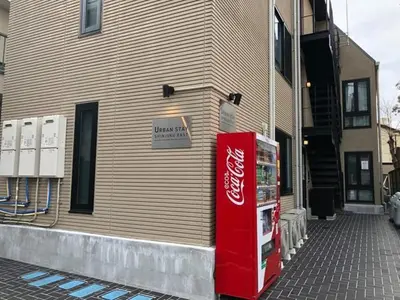 a cocacola machine sitting outside of a building at URBAN STAY SHINJUKU EAST - Vacation STAY 67909v in Tokyo