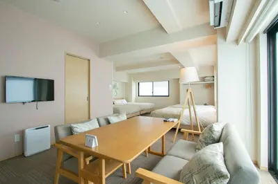 a living room with a table and a couch at Ostay Ueno in Tokyo
