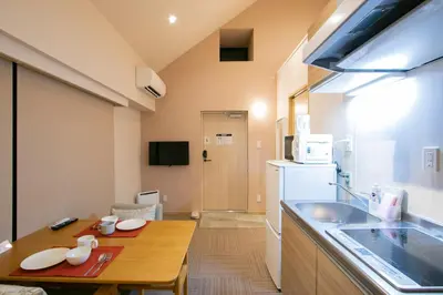 a small kitchen with a table and a sink at Ostay Ueno in Tokyo