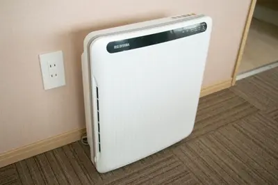 a white refrigerator sitting on the corner of a room at Ostay Ueno in Tokyo