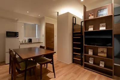 a kitchen and dining room with a table and a tv at COCOSHUKU Asakusa Kuramae in Tokyo
