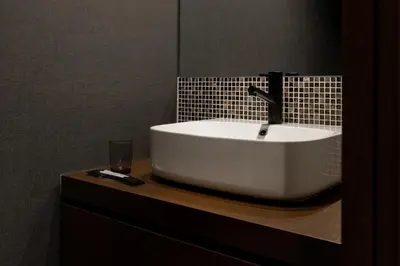 a white sink on a counter in a bathroom at COCOSHUKU Shinjuku-Hanazono in Tokyo