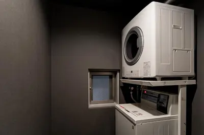 a microwave oven sitting on top of a machine at COCOSHUKU Shinjuku-Hanazono in Tokyo