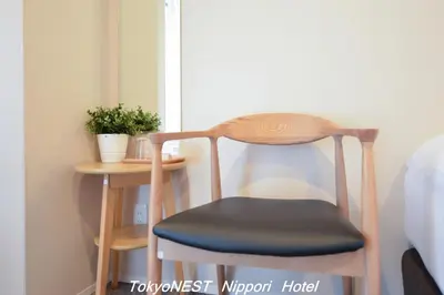 a wooden chair sitting next to a small table at TokyoNEST Nippori in Tokyo