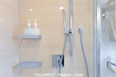 a shower in a bathroom with a glass door at TokyoNEST Nippori in Tokyo
