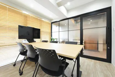 a conference room with a wooden table and chairs at TokyoNEST Nippori in Tokyo