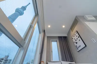 a room with a large window with the eiffel tower at ZAITO Tokyo Mukojima Hotel \u62bc\u4e0a\u99c5\u5f92\u6b69\u4e03\u5206\u30db\u30c6\u30eb in Tokyo