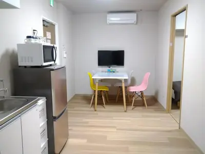 a small kitchen with a small table and a microwave at Hitoyado Ryokan Higashiueno - Vacation STAY 72556v in Tokyo