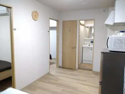 a kitchen with a microwave and a door to a room at Hitoyado Ryokan Higashiueno - Vacation STAY 72556v in Tokyo