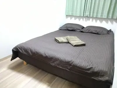 a bed with two pillows on it in a bedroom at Hitoyado Ryokan Higashiueno - Vacation STAY 72552v in Tokyo