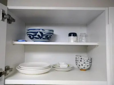 a shelf with plates and bowls in a kitchen at Hitoyado Ryokan Higashiueno - Vacation STAY 72558v in Tokyo