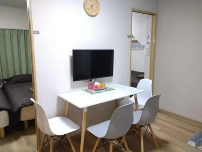 a room with a white table with chairs and a tv at Hitoyado Ryokan Higashiueno - Vacation STAY 72541v in Tokyo