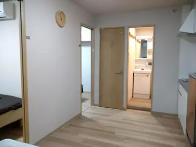 a hallway with a door leading to a kitchen at Hitoyado Ryokan Higashiueno - Vacation STAY 72546v in Tokyo