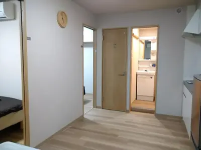 a hallway with a door leading to a kitchen at Hitoyado Ryokan Higashiueno - Vacation STAY 72546v in Tokyo