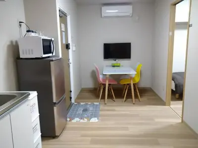 a small kitchen with a small table and a microwave at Hitoyado Ryokan Higashiueno - Vacation STAY 72546v in Tokyo