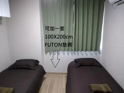 a bedroom with two beds and a window with a sign at Hitoyado Ryokan Higashiueno - Vacation STAY 72546v in Tokyo