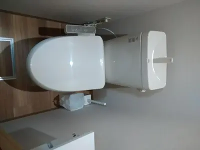 a toilet in a bathroom with a white tank at Hitoyado Ryokan Higashiueno - Vacation STAY 72534v in Tokyo