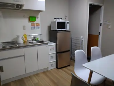 a small kitchen with a sink and a microwave at Hitoyado Ryokan Higashiueno - Vacation STAY 72534v in Tokyo