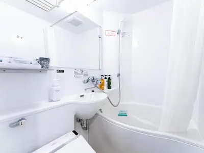 a white bathroom with a sink and a shower at APA Hotel Ueno Ekiminami in Tokyo