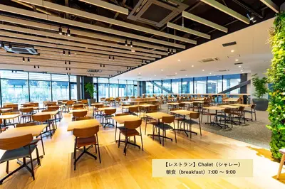 a cafeteria with tables and chairs and windows at L stay & grow Minami Sunamachi in Tokyo