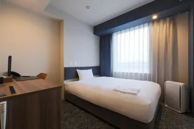 a bedroom with a bed and a desk with a computer at L stay & grow Minami Sunamachi in Tokyo